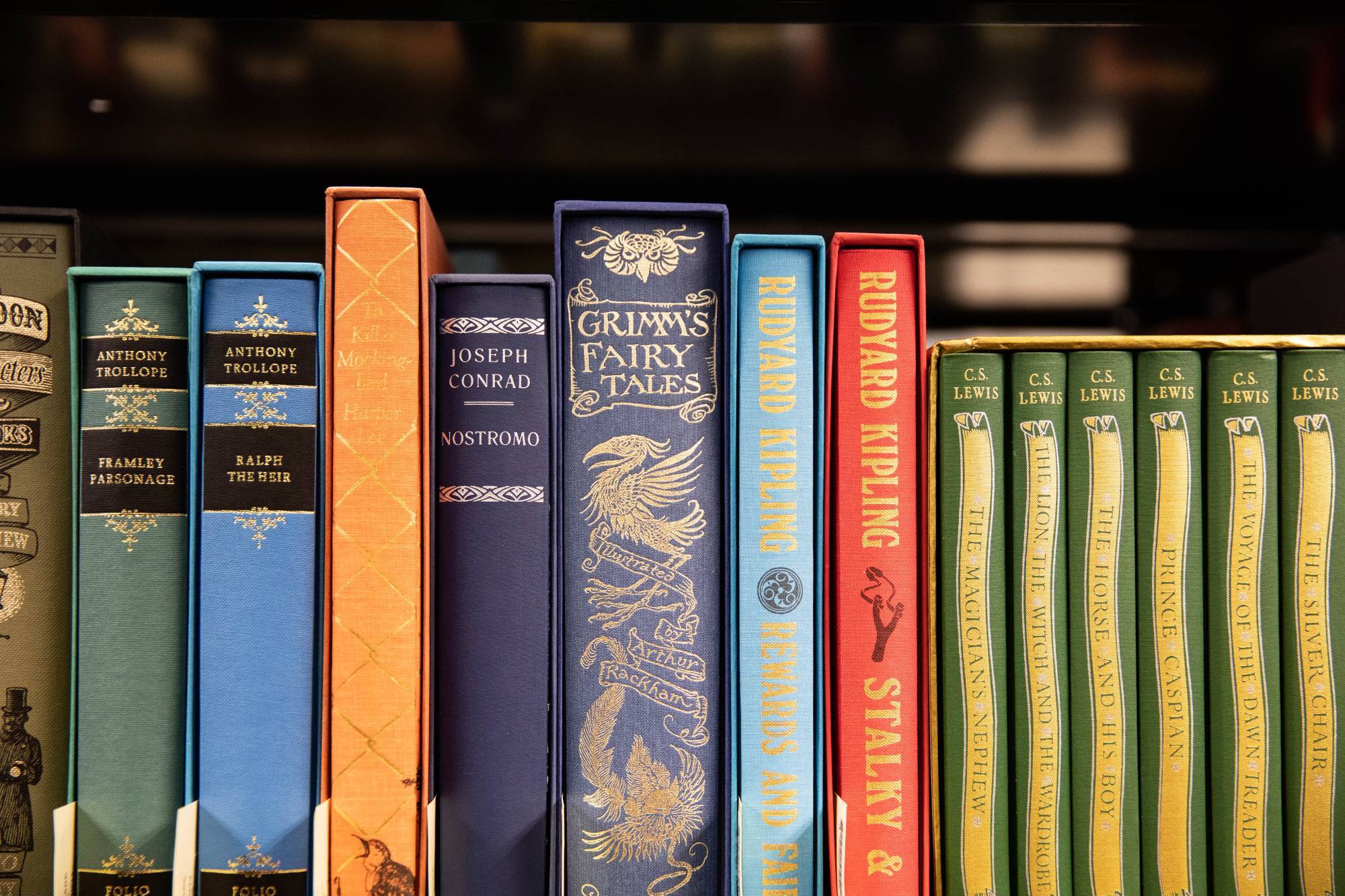 A colorful display of books on a shelf including the Grimm's Fairy Tales